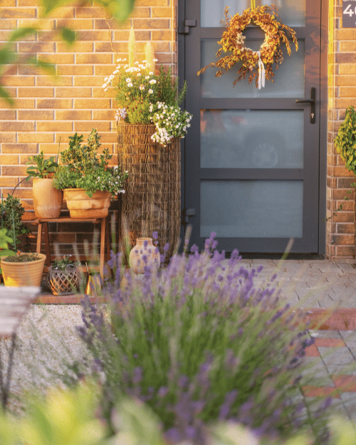 front porch decorated with potted flowers