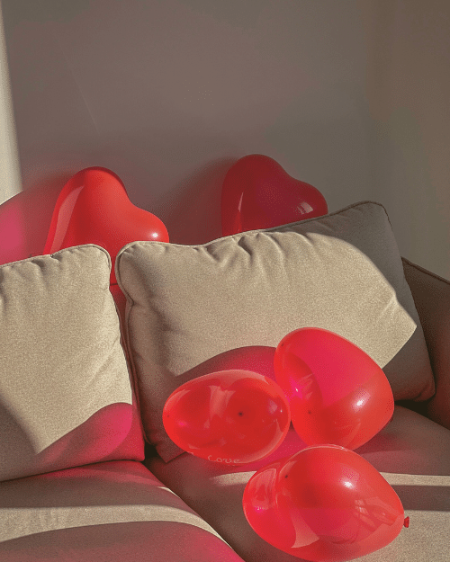 red heart shaped balloons on sofa