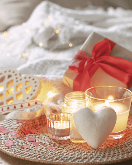 valentines day centerpiece with heart shaped decorations and candle