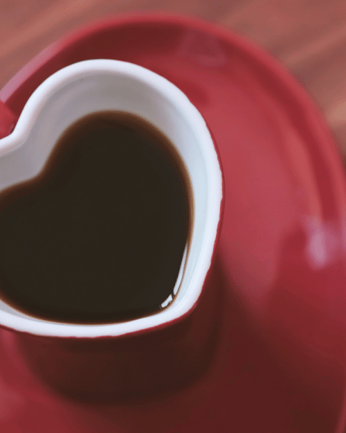 red heart shaped coffee cup and saucer