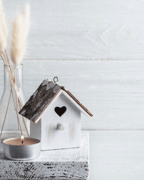 small wooden decorative bird house with heart shaped hole