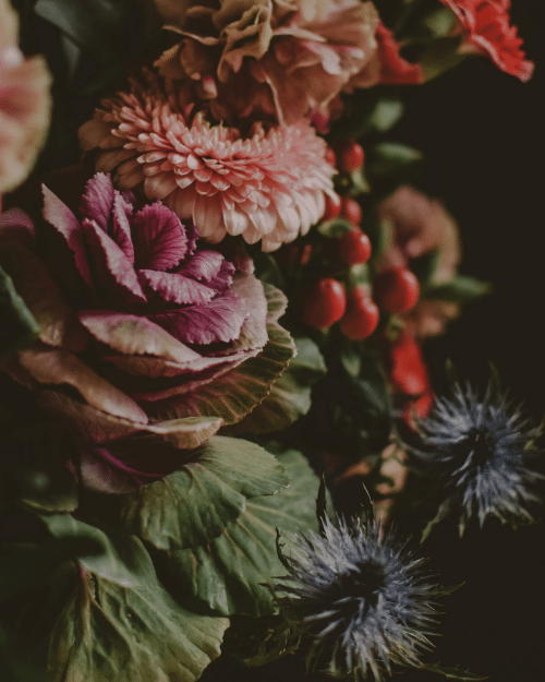 arrangement of seasonal flowers including thistles