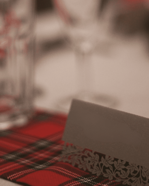 tartan table runner with place card with intricately carved flowers cut out