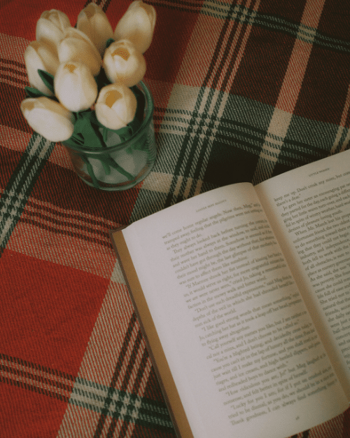 tartan table cloth with book and vase of flowers